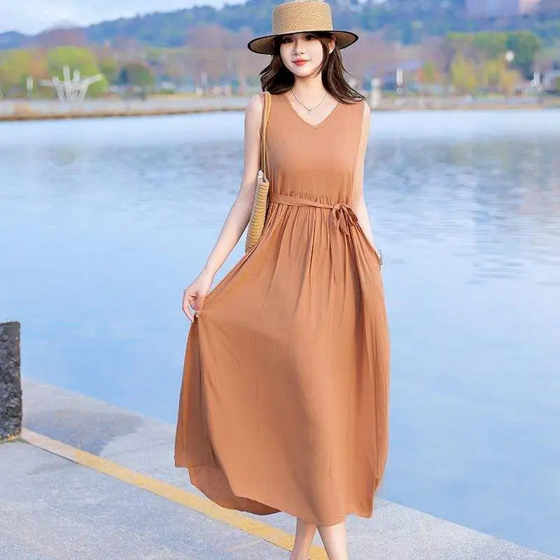 Women's V-neck maxi dress featuring a flattering tie waist, sleeveless design & deep side pockets.
