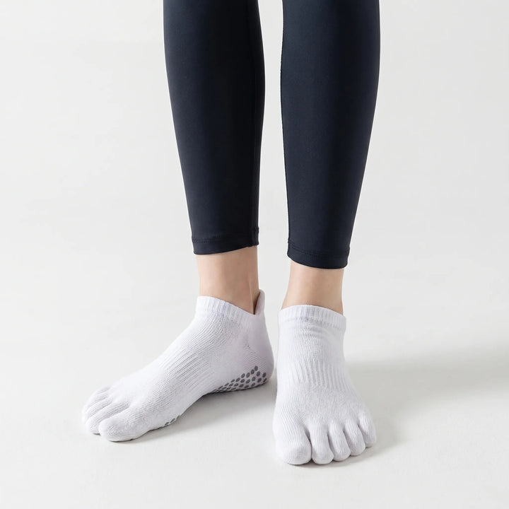 Close-up of the textured non-slip grips on women's five-toe yoga socks, ensuring secure footing for pilates & barre.