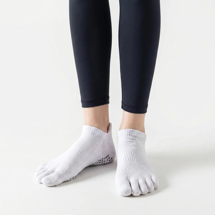 Five-toe design of women's grip socks, promoting better toe spread and stability for yoga, pilates, and studio fitness.