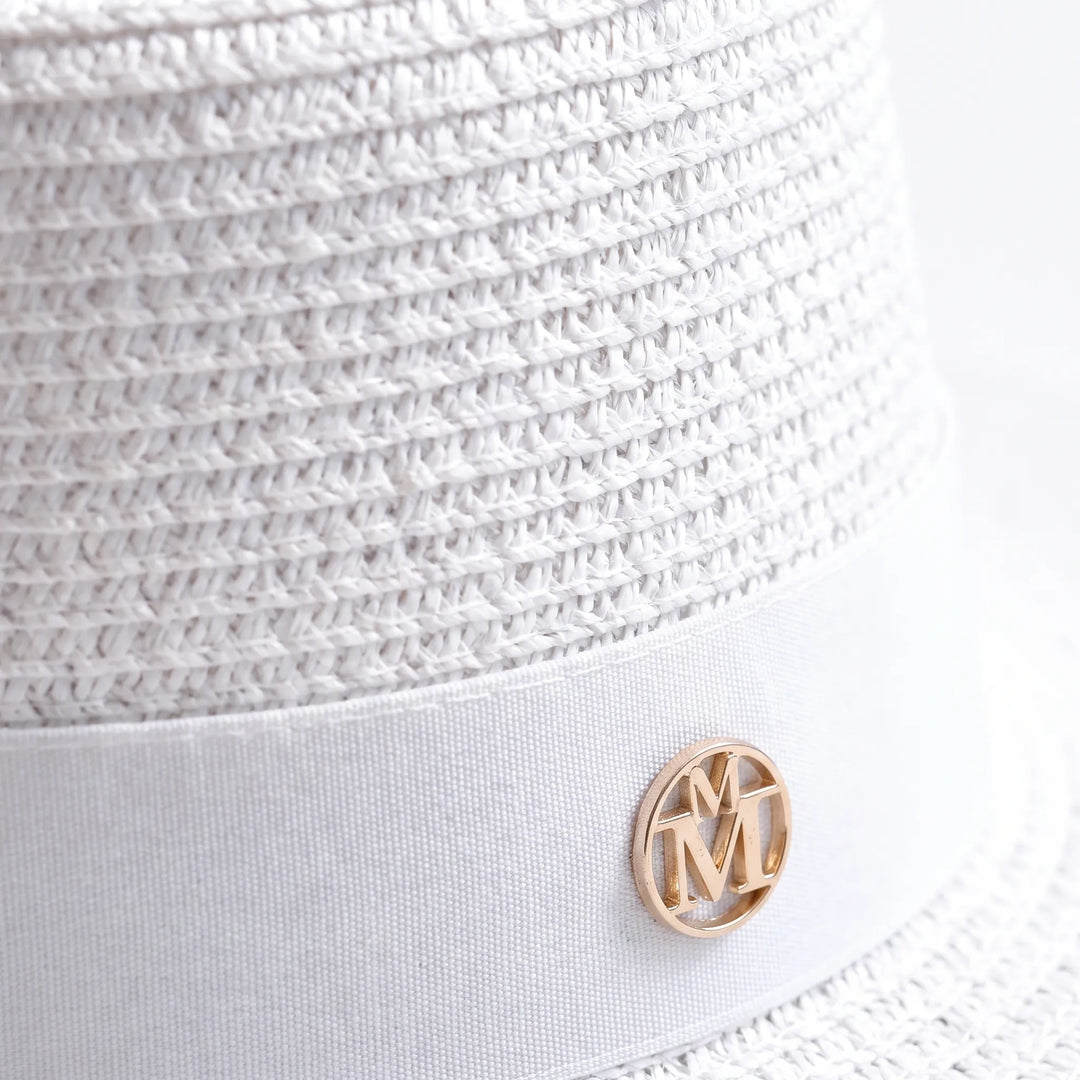 Elegant woven sun hat for women, featuring a chic flat top and wide brim for ultimate sun protection.