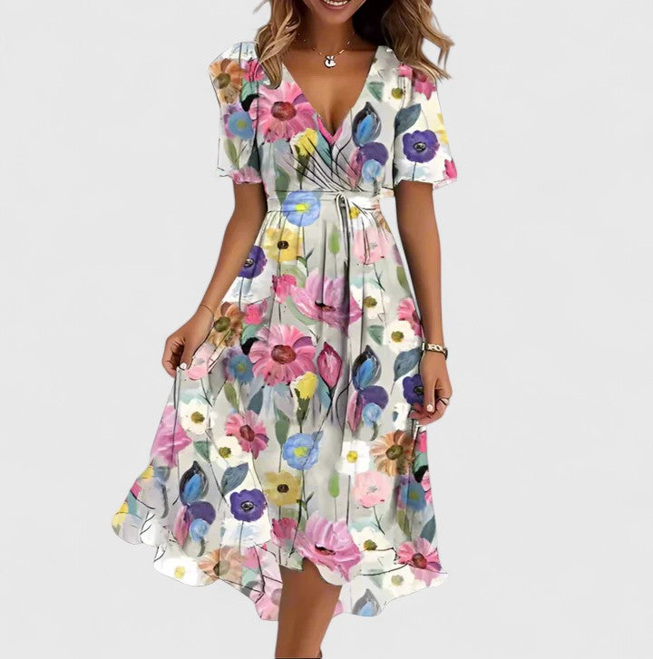 Model wearing a women's vibrant floral print midi dress with comfortable flutter sleeves & V-neck.