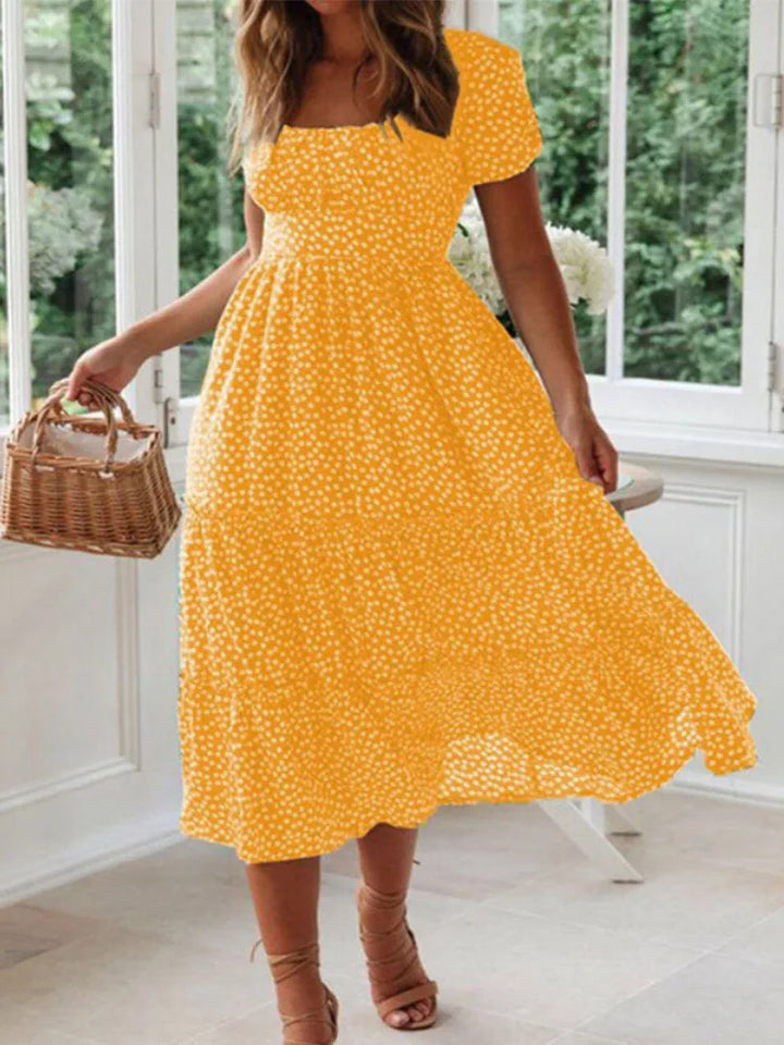 Smocked floral print maxi dress for women, flowy design, puff sleeves. Perfect for a chic countryside summer look.