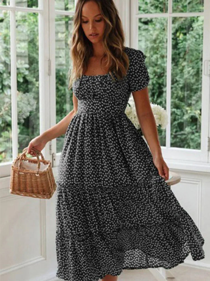 Casual women's floral meadow maxi dress with smocked top & flowy skirt. Perfect for summer beach or vacation.