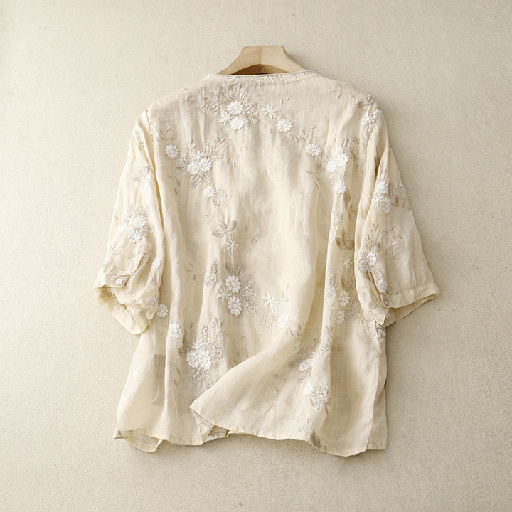 Close-up of a women's relaxed fit blouse featuring intricate floral embroidery, ideal for summer tops.