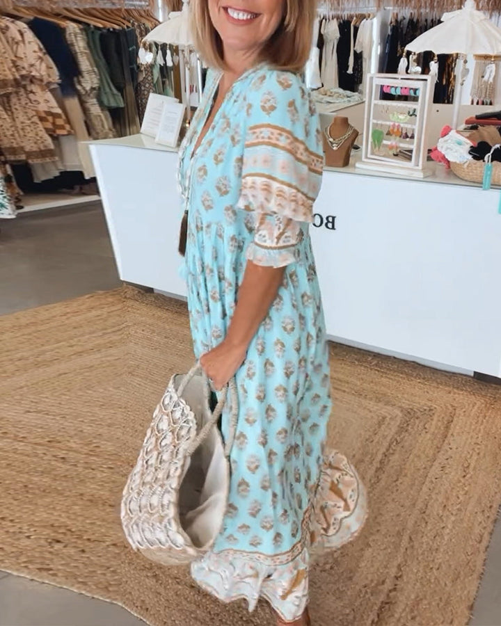 Stylish women's V-neck flowy midi dress with bohemian flair, suitable for casual spring outings.