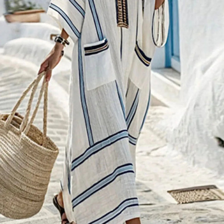 Elegant women's V-neck kimono maxi dress with pockets, worn for a stylish and comfortable beach or vacation look.