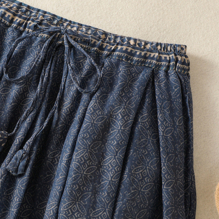 Elegant women's printed midi skirt, flowy and comfortable, featuring a stylish pattern and drawstring waist.