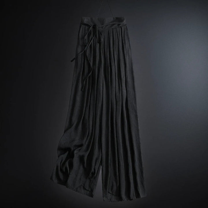 Lightweight women's flowy wide-leg summer pants with a flattering high waist and adjustable tie. Effortlessly stylish.