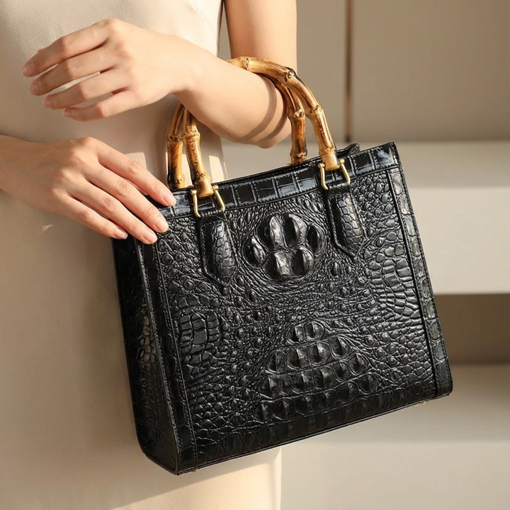 Elegant genuine leather handbag for women, featuring a chic crocodile pattern & sturdy bamboo handle.