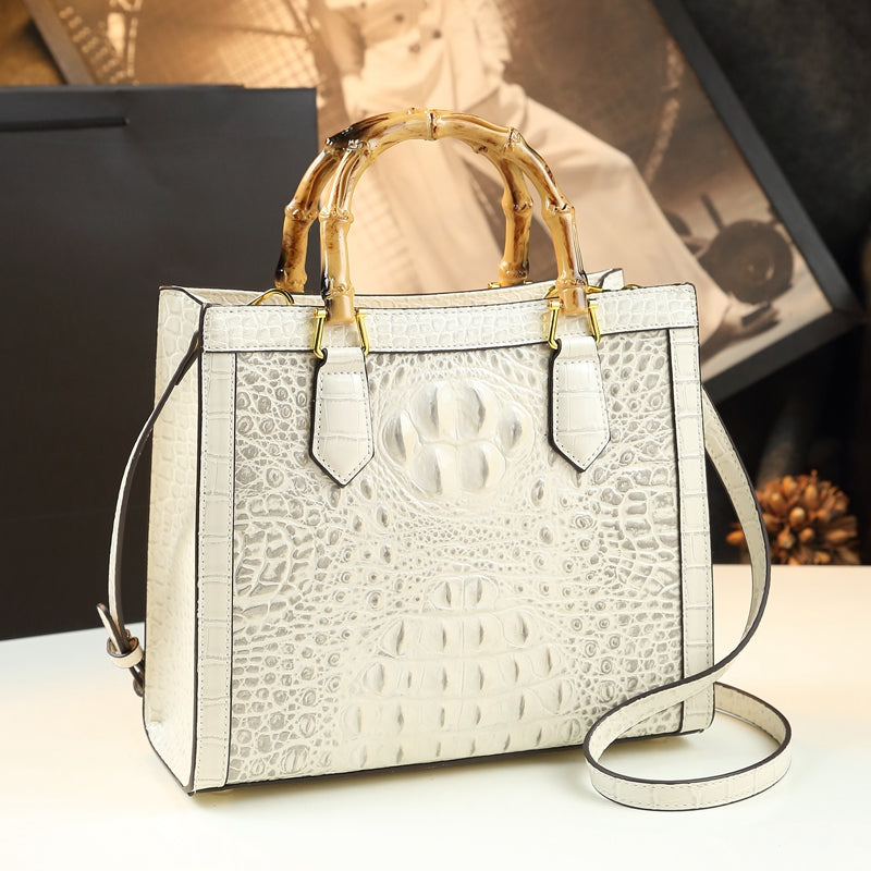 Genuine leather women's handbag, sophisticated crocodile pattern, and natural bamboo top handle. Elegant gift.
