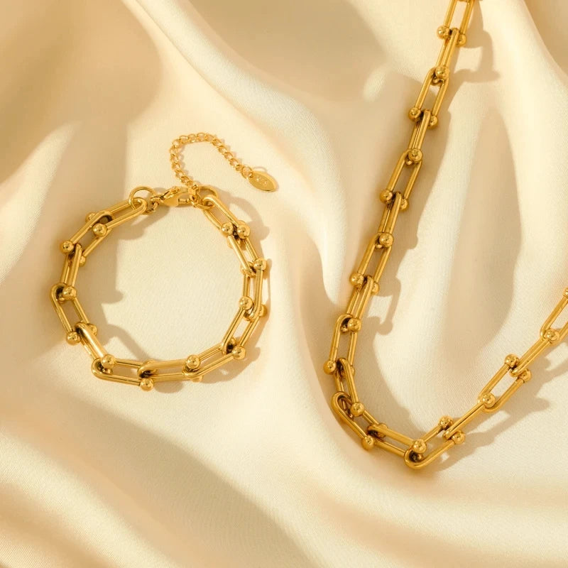 Model wearing elegant women's gold link chain necklace. Gold-plated stainless steel, a timeless statement piece.