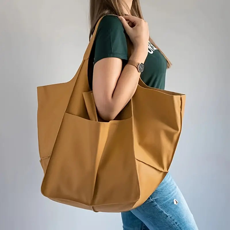 Elegant Women's Grand Carryall Tote, a statement bag & travel essential with secure closure.