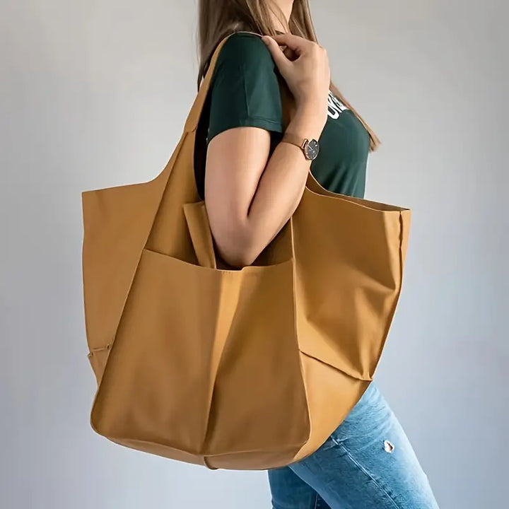 Elegant Women's Grand Carryall Tote, a statement bag & travel essential with secure closure.