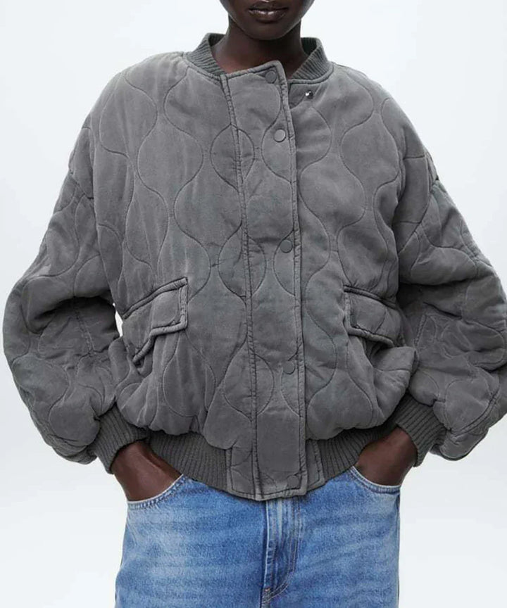 Cozy women's gray quilted bomber jacket. Ideal outerwear for chic fall and winter fashion. Everyday style.