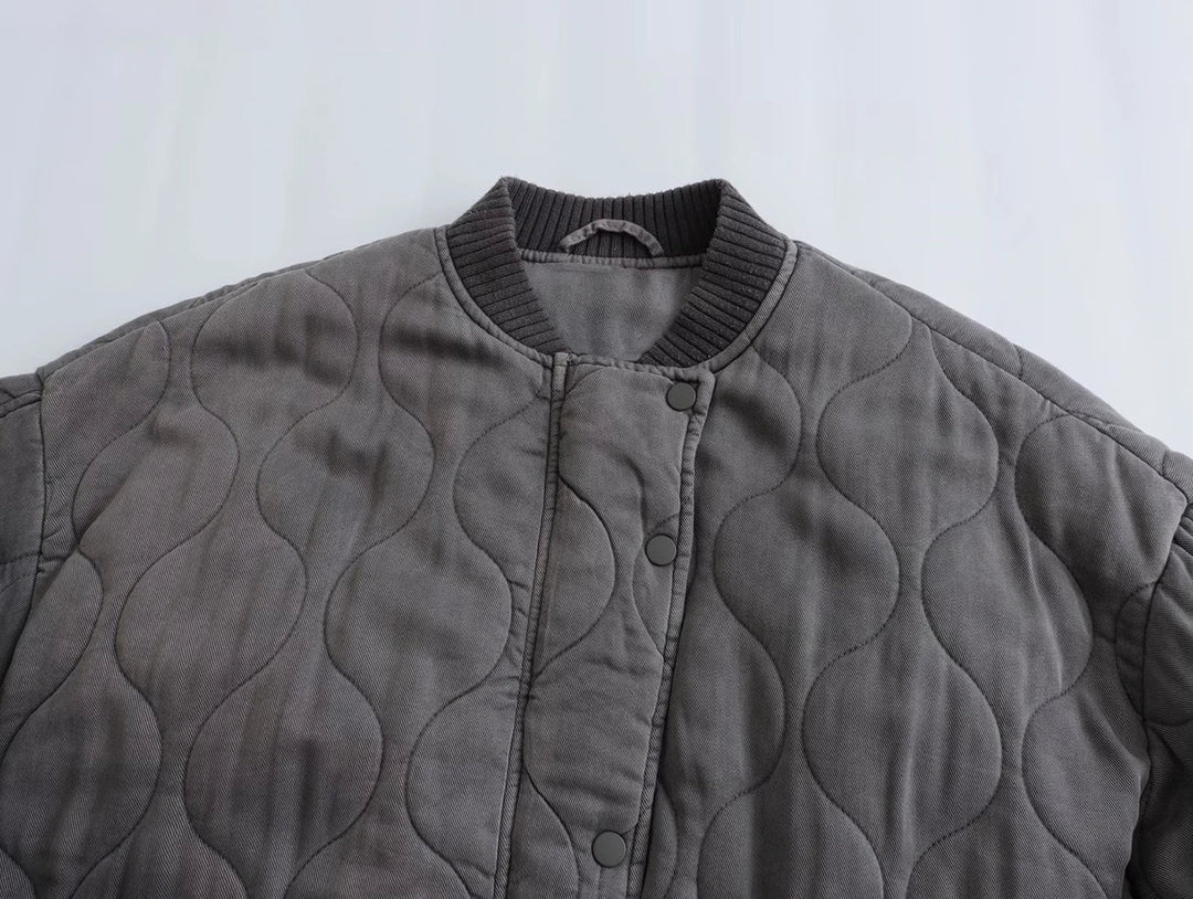 Chic women's quilted bomber jacket in gray. Cozy and versatile outerwear for fall & winter casual style.