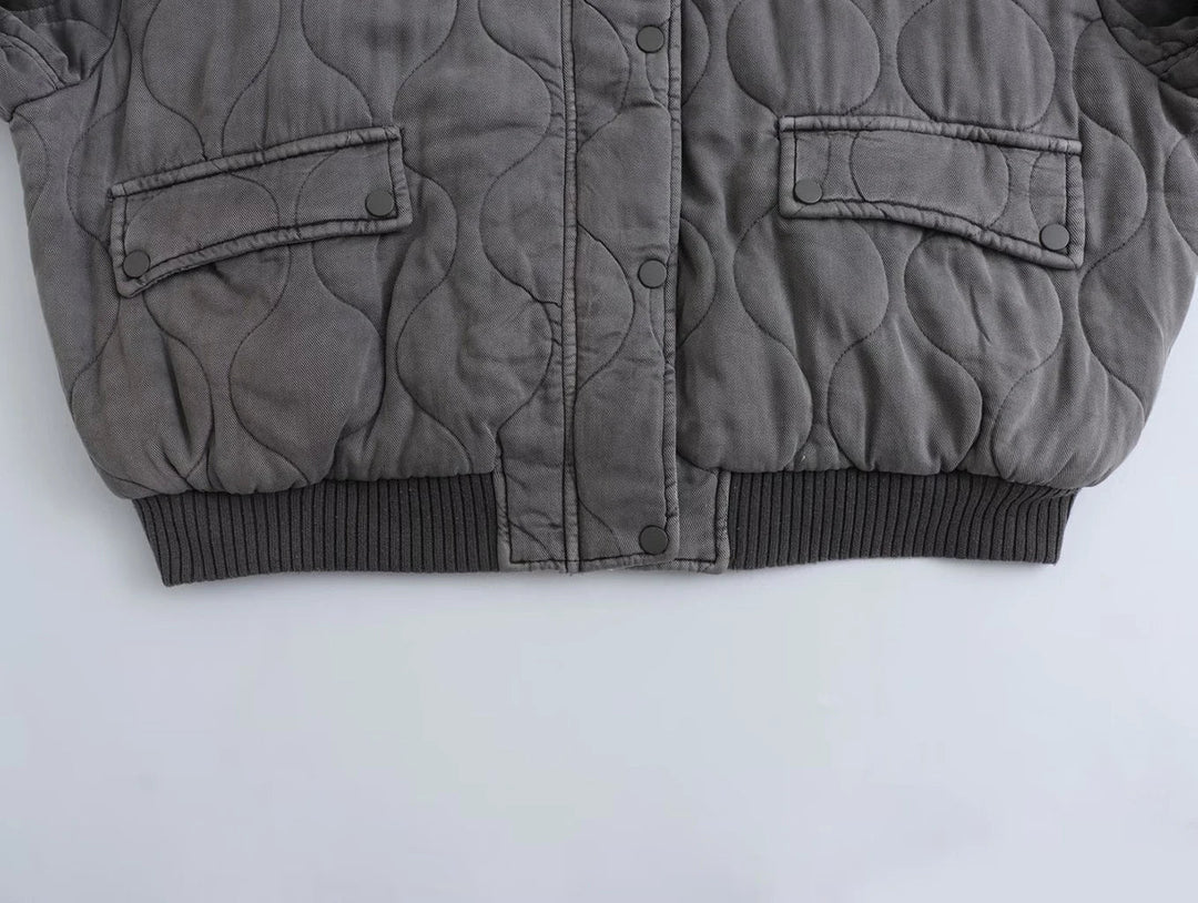 Women's modern gray quilted bomber jacket. Cozy and chic outerwear, perfect for everyday fall & winter style.