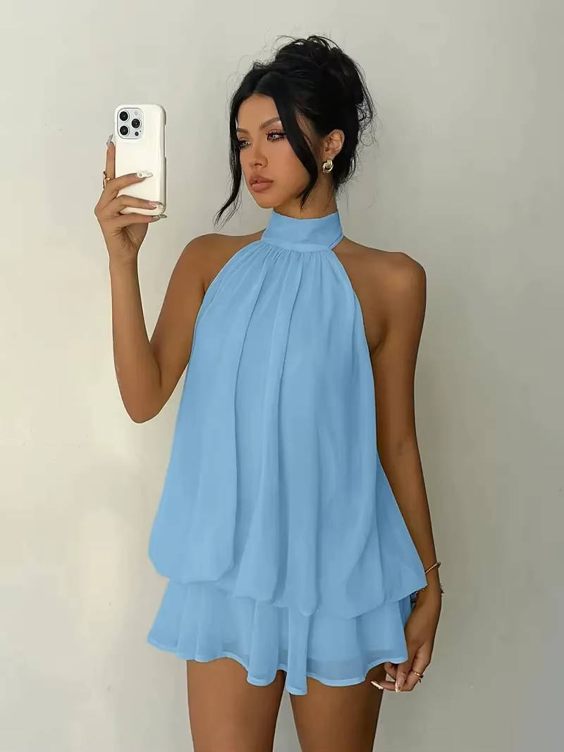 Sleek women's open-back mini dress with a flattering halter neckline and delicate ruffle hem detail.