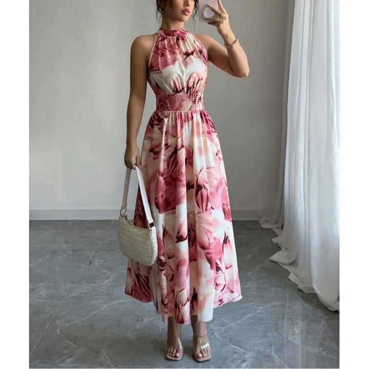 Stylish women's abstract print maxi dress with halter neck and smocked waist. Ideal for summer elegance.