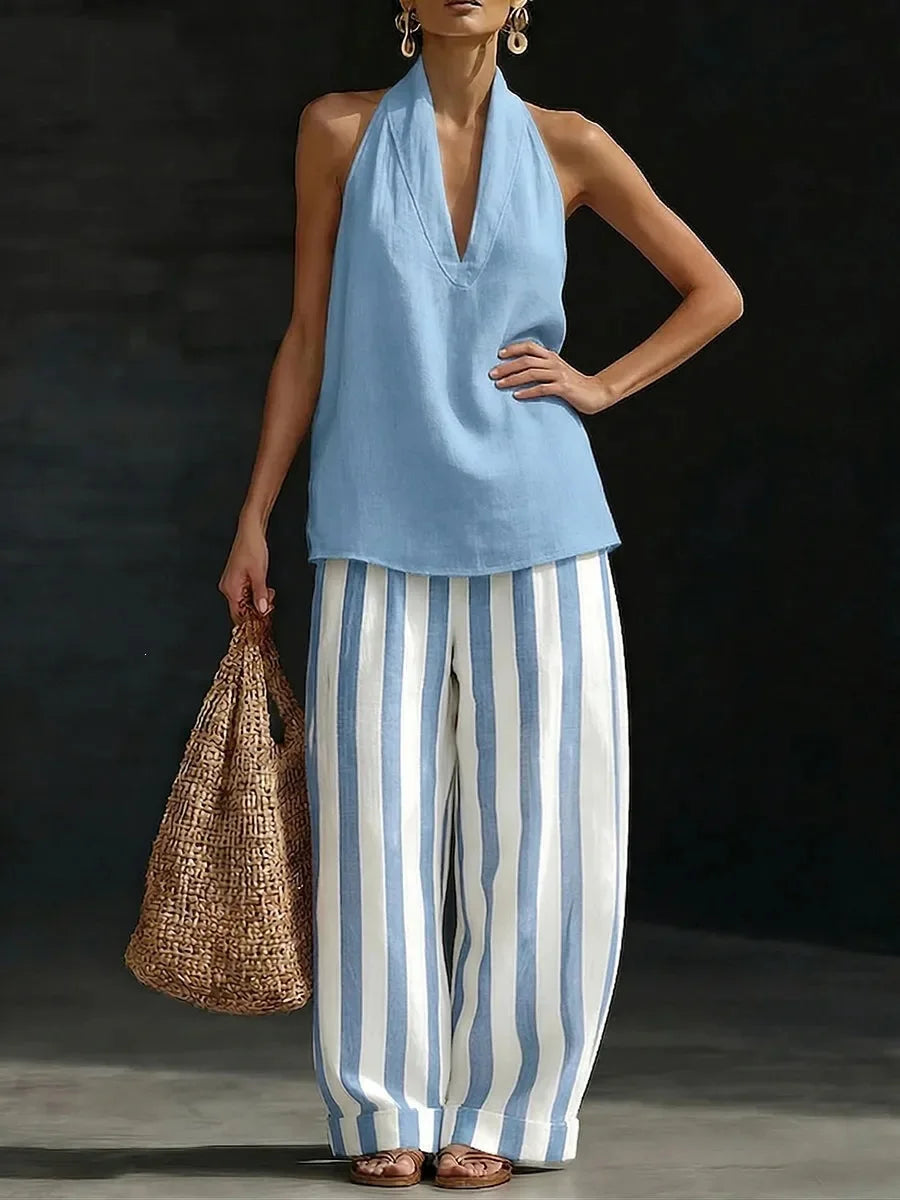 Effortless women's matching outfit: sleeveless halter top and high-waisted wide leg pants. Perfect for travel.