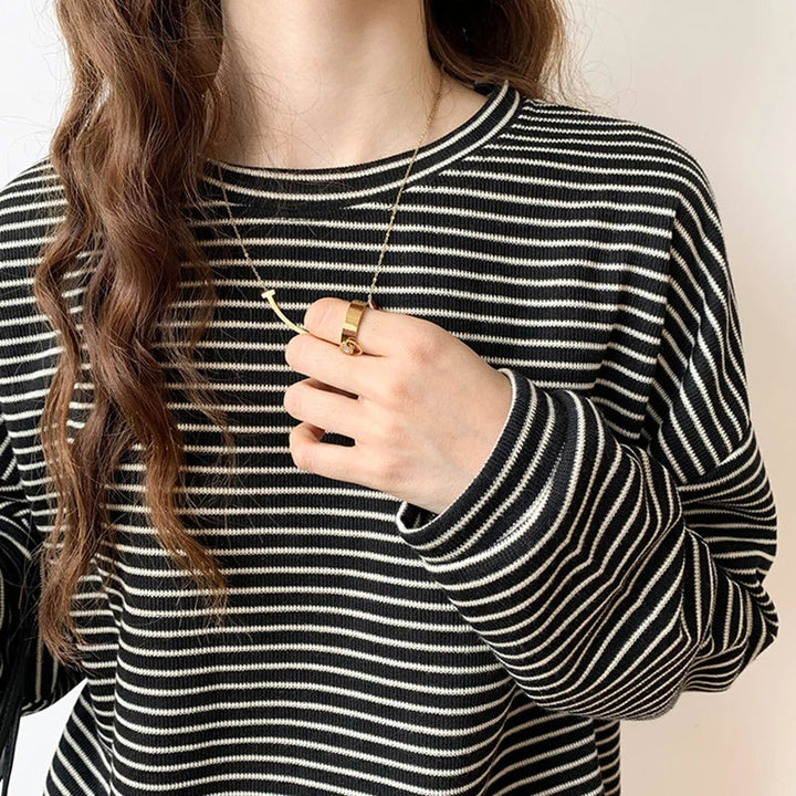 Versatile women's relaxed top with heritage stripes. Long sleeve, crewneck, ideal for casual layering.