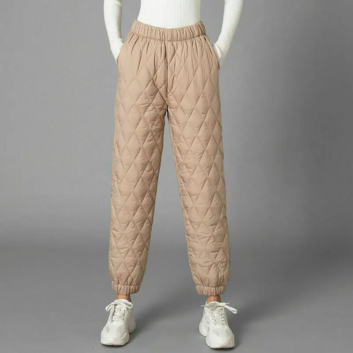 Woman models comfortable high-rise puffer joggers, great for winter loungewear & casual style.