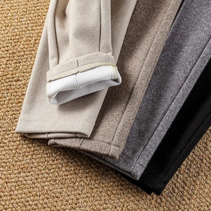 Textured herringbone pattern on classic high-waisted women's tailored trousers, sophisticated & timeless.