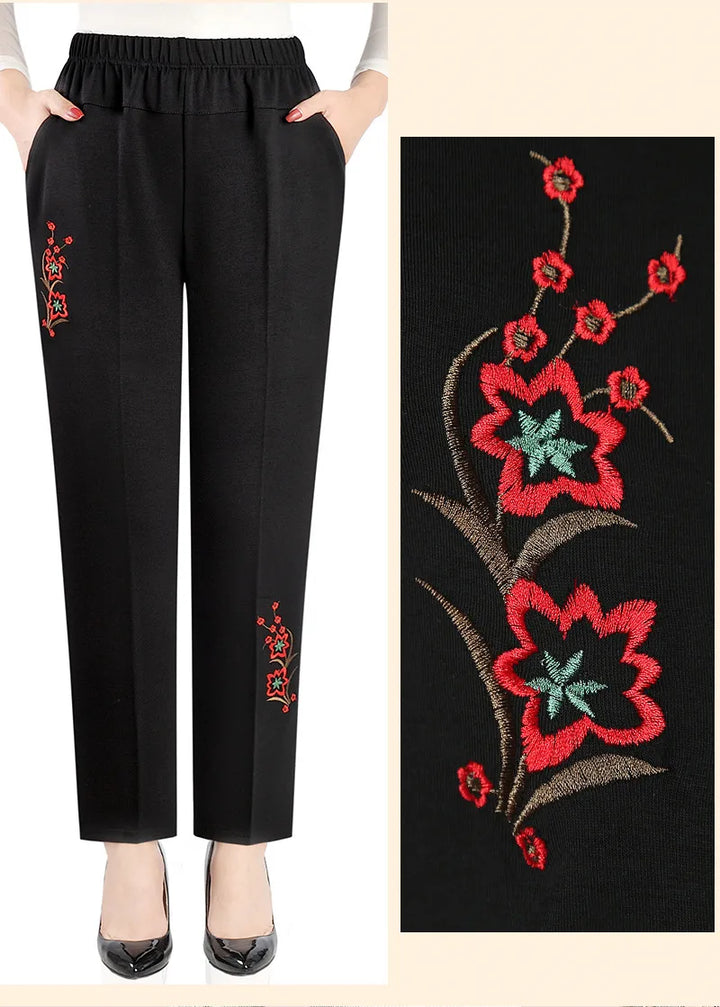 Oversized yet flattering women's high-waisted plus size pants with intricate floral embroidery.