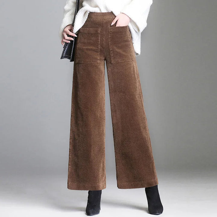 Stylish women's retro-inspired flare trousers featuring distinctive high-waisted design & patch pockets.