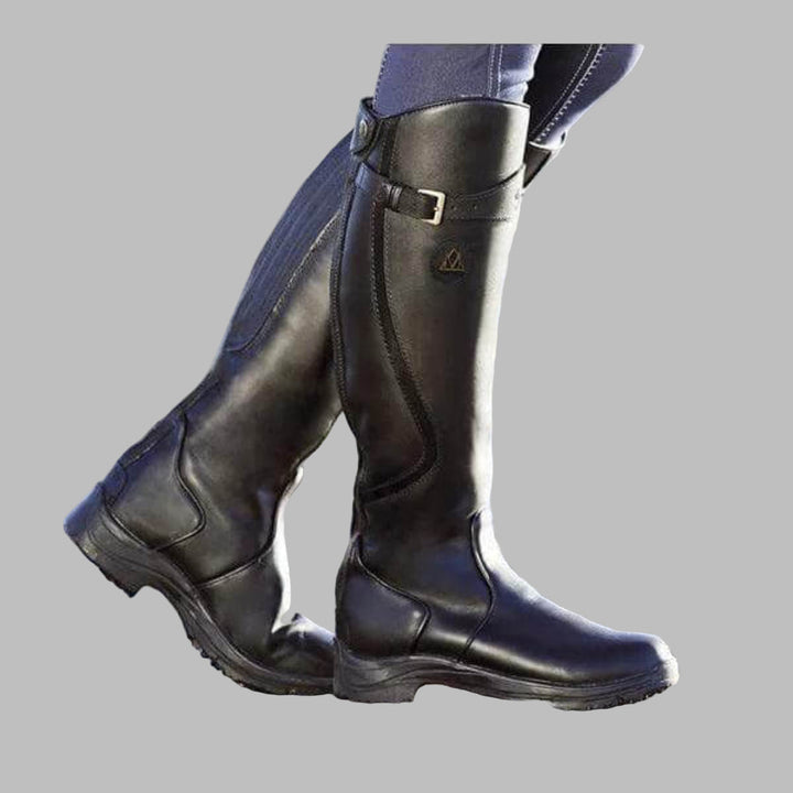 Stylish women's knee-high adventure boots with buckles, perfect for hiking, fall fashion, or a casual rugged look.
