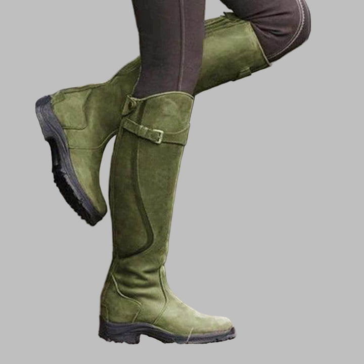 Women's knee-high buckled hiking boots, durable outdoor footwear for adventurers, great for fall & winter.