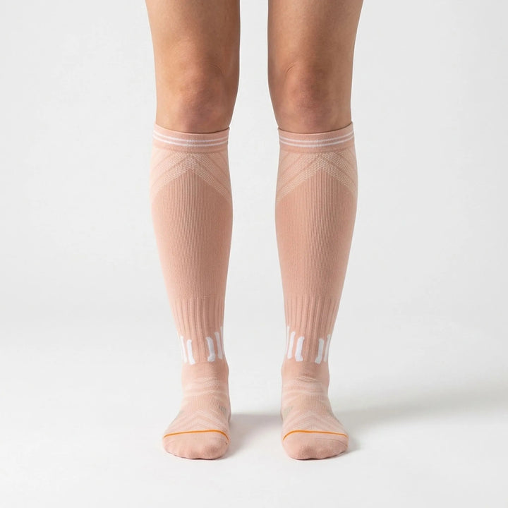 Comfortable women's knee-high compression socks, ideal for long flights & travel to prevent swelling.