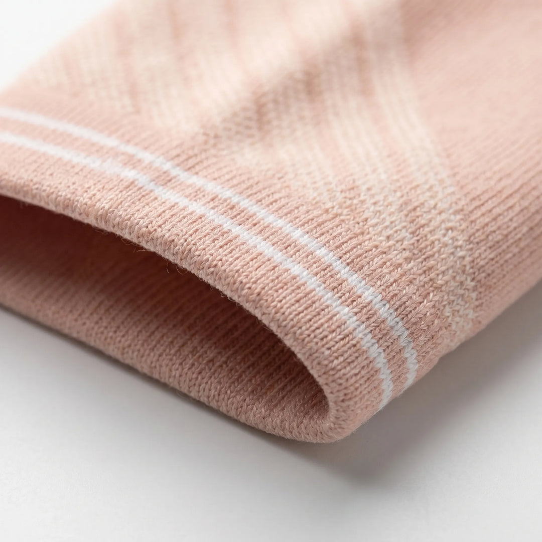 Athletic women's knee-high compression socks providing support for active lifestyles & recovery.