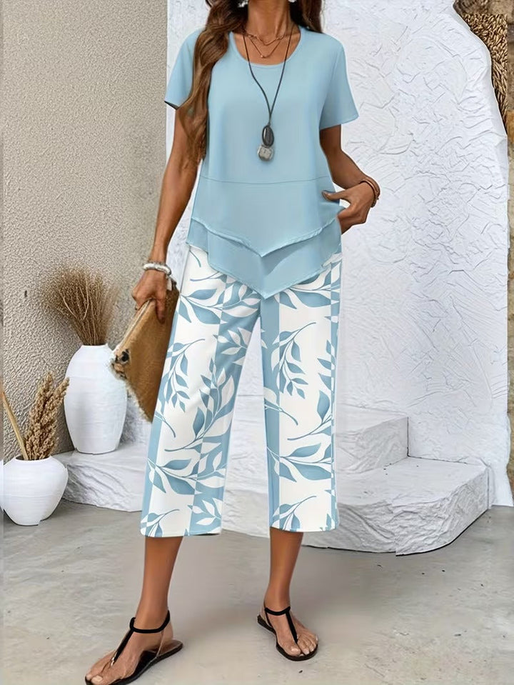 Stylish women's two-piece set featuring a vibrant leaf print & comfortable cropped trousers.