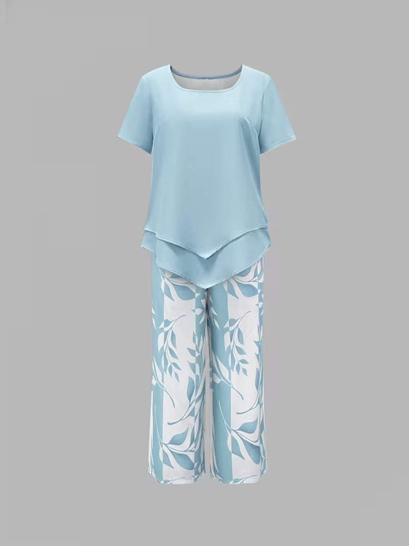 Vibrant leaf print women's two-piece set for summer. Includes a stylish top & cropped trousers.