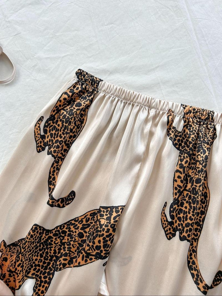 Soft women's leopard print silk satin pajama set, ideal for stylish loungewear & comfortable sleep.