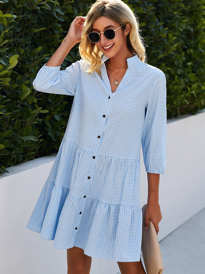 Women's light blue & pink gingham tiered mini dress with button-down front, perfect for summer casual wear.