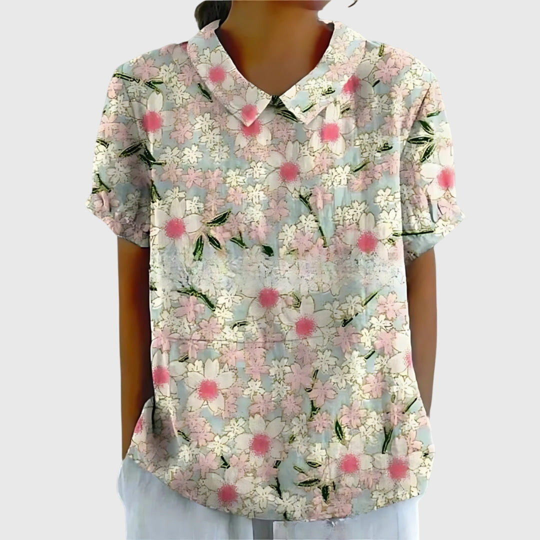 Relaxed fit women's summer top featuring a vibrant floral print and elegant collar.