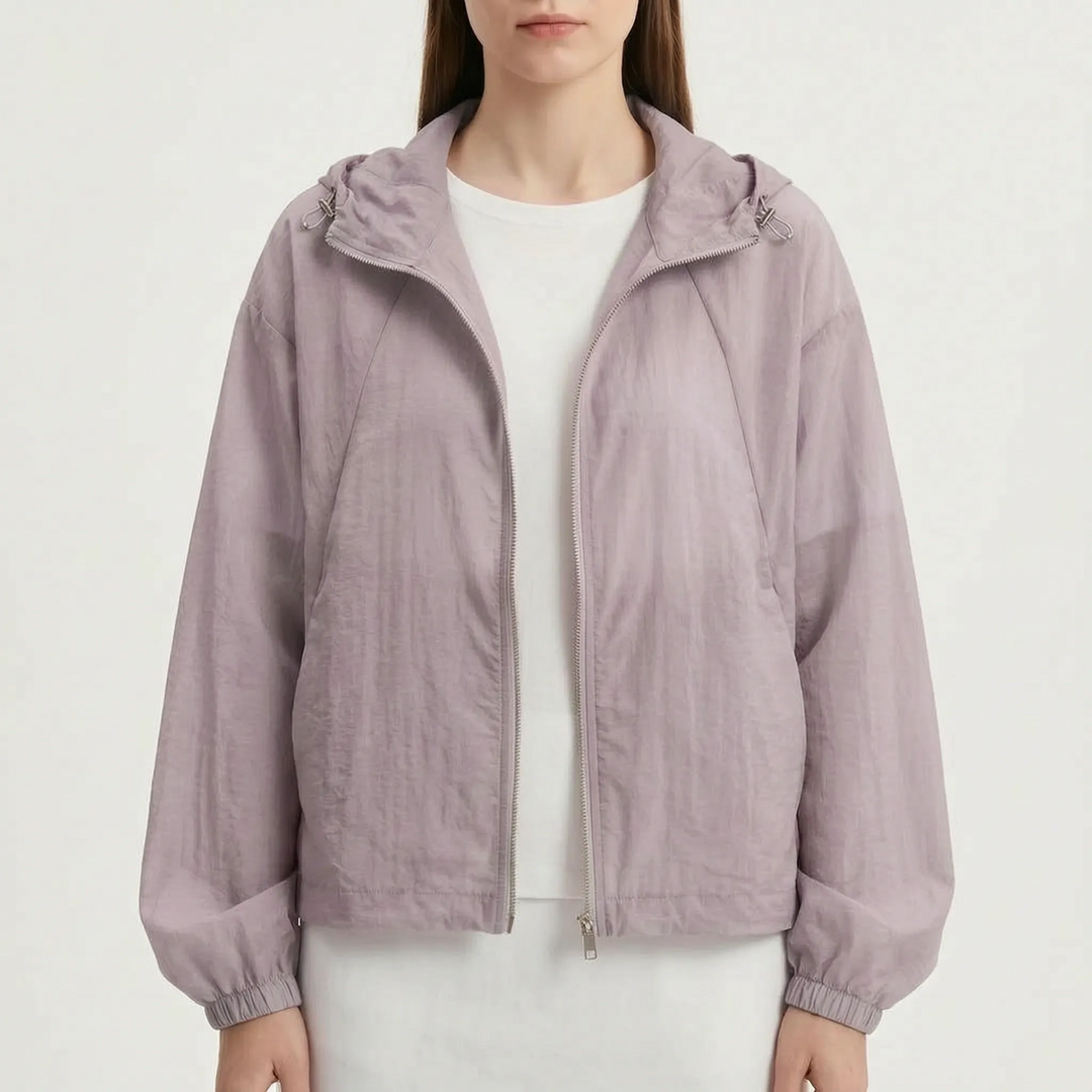 Transitional women's lightweight hooded windbreaker jacket, ideal for layering during spring and cool summer nights.