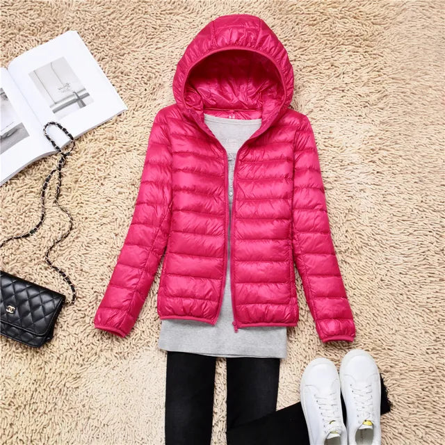 Women's lightweight packable hooded jacket in black for versatile travel & outdoor adventures.