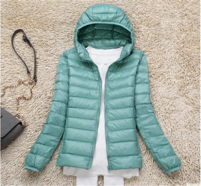 Women's pink packable hooded jacket, lightweight & warm. Stylish travel coat for women.