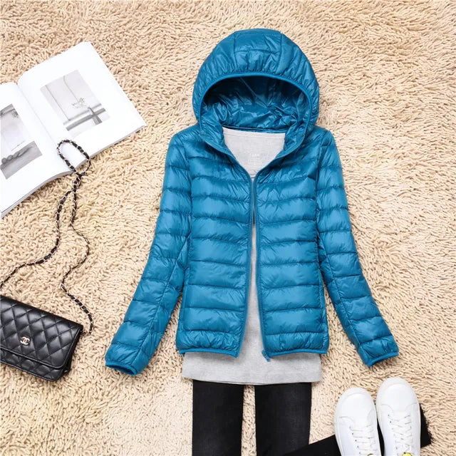 Women's lightweight hooded jacket. Packable design offers warmth & protection for travel.