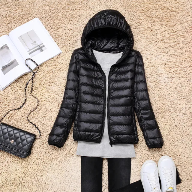 Women's lightweight winter coat with hood, packable & warm. Essential for cold weather travel.