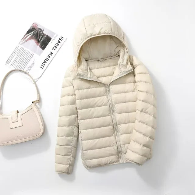 Packable women's hooded jacket, ideal for travel. Lightweight & warm insulated outerwear.
