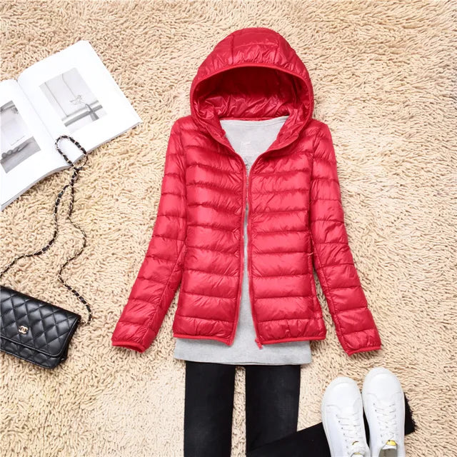 Stay warm in this women's lightweight hooded jacket. Packable winter coat for travel.