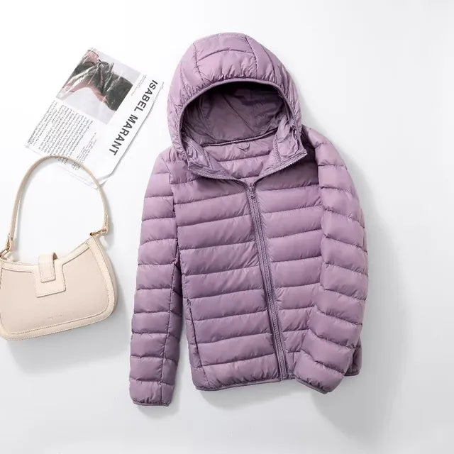 Chic women's hooded jacket, packable & lightweight. Ideal travel outerwear for style & warmth.
