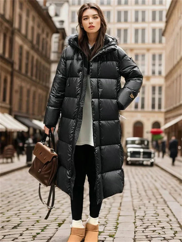 Women's outdoor quilted hooded maxi winter jacket. Padded, warm coat perfect for cold weather activities.