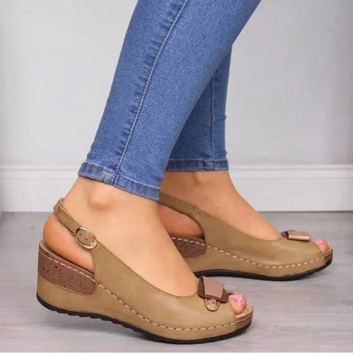 Casual women's low wedge sandals featuring a peep toe and secure slingback design for summer footwear.