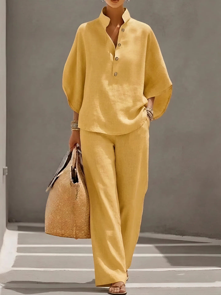 Fashionable women's two-piece outfit: mandarin collar top and elegant wide-leg pants.