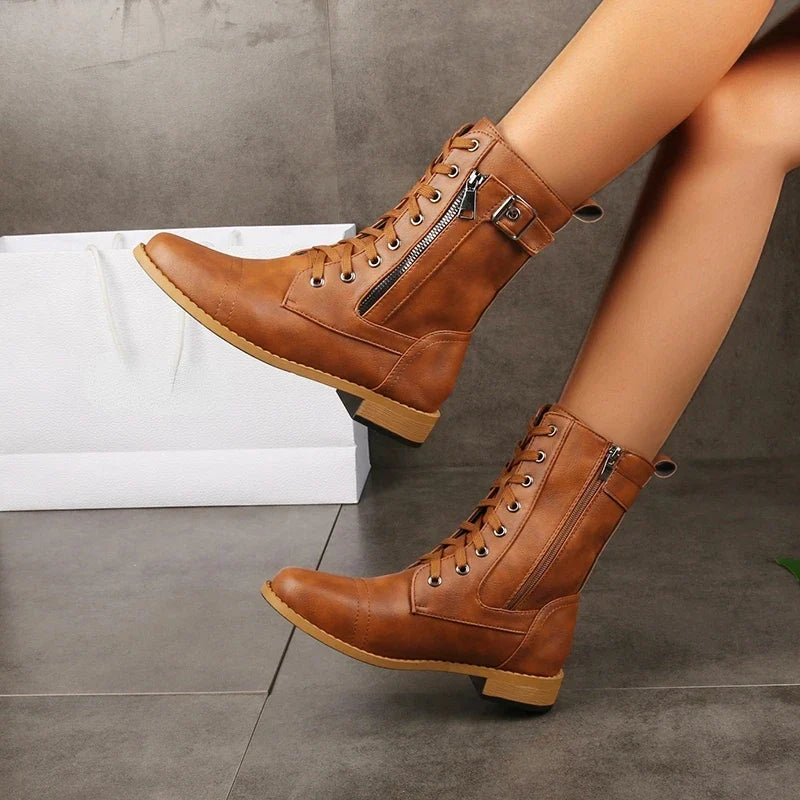 Edgy women's Mason mid-calf boots, showcasing trendy lace-up design with decorative buckles. Fashionable footwear.