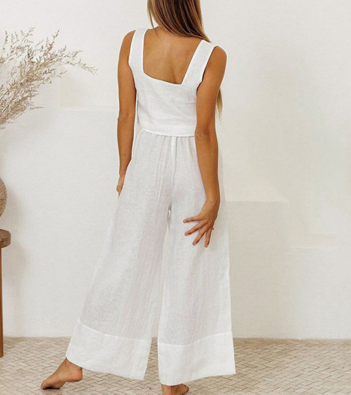 Full shot of a woman wearing a chic minimalist two-piece set: square neck top & wide-leg pants. Modern & elegant outfit.